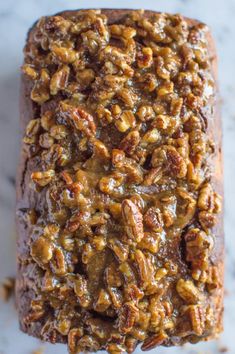 a loaf of bread with nuts on top