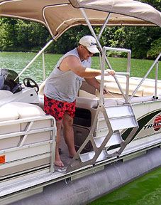 a man standing on the back of a white boat