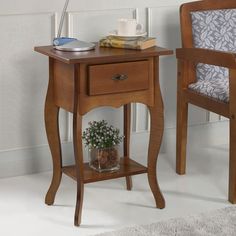 a small table with a chair next to it and a potted plant on top