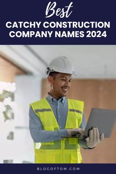 A man in a hard hat holding a laptop while brainstorming construction company names for 2024.