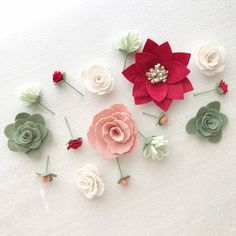 paper flowers are arranged on a white surface