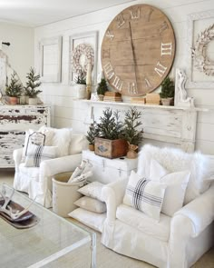 a living room filled with furniture and a large clock on the wall above it's mantle