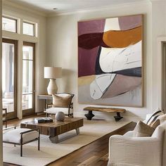 a living room filled with furniture and a painting on the wall