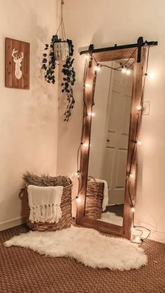 a room with a mirror, rug and lights on the wall next to a door