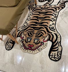 a tiger rug is on the floor next to a couch