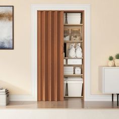 an open door in a room with white and brown decor on the walls, along with several storage bins