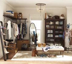 an organized closet with clothes, shoes and other items on display in the center area