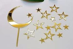 gold stars and crescents on a white surface