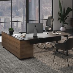 an office desk with two laptops and a chair in front of a large window