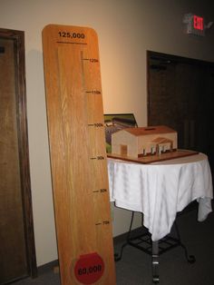 a tall wooden ruler sitting on top of a table