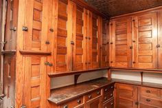 an empty kitchen with wooden cabinets and drawers