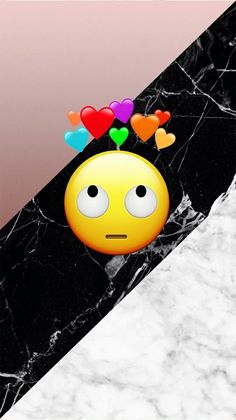 an emoticive smiley face with hearts on top of it's head in front of a black and white marble background