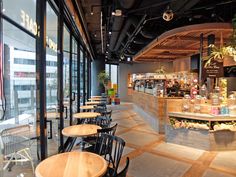 an empty restaurant with wooden tables and chairs