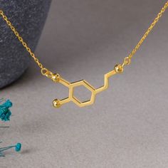 "Dopamine Molecule Necklace 925 Sterling Silver, Chemistry Necklace, Dopamine Jewelry, Science Gift, Gift for her, Mothers day gift Product Description: This elegant and meaningful necklace is specially designed for chemistry and science enthusiasts. The striking and unique shape of the dopamine molecule turns this necklace into both a stylish accessory and a scientific statement. Crafted with the brilliance of sterling silver and 925 hallmark quality, this necklace is a perfect choice for both Dopamine Jewelry, Chemistry Necklace, Dopamine Molecule, Molecule Necklace, Meaningful Necklace, Science Gifts, Gift Product, Cute Earrings, Stylish Accessories