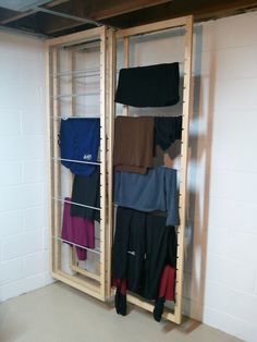 there are many pants hanging on the rack in this room with no one around them