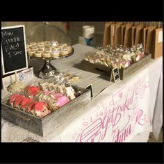 a table topped with lots of pastries and cupcakes on top of it