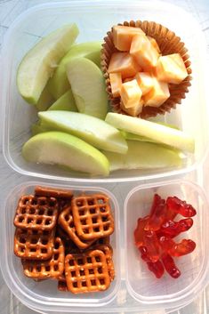 an assortment of fruit and pretzels in plastic containers