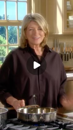 a woman standing in front of a stove with pots and pans on it