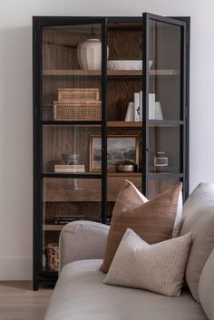 a living room filled with furniture and lots of shelves