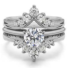 a white gold engagement ring set with an oval diamond center and two rows of diamonds on the band