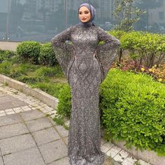 Experience elegance and sophistication with the Dreamy Vow Luxury Beaded Gray Muslim Evening Dress. Featuring intricate beading and a flattering flare silhouette, this dress is perfect for any formal occasion. The long sleeves add a touch of modesty, making it suitable for Muslim women. Elevate your style and make a statement at any wedding or party with this stunning gown. Hijabi Prom Dress, Muslim Gown, Arabic Women, Custom Flower Girl Dress, Ceremony Outfit, Outfits Muslim, Yellow Evening Dresses, Silver Evening Dress, Purple Evening Dress