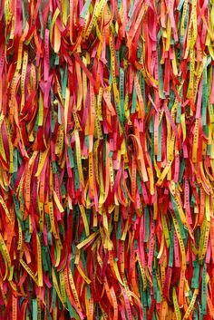 colorful streamers hanging on the side of a building