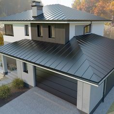 an aerial view of a house with a metal roof