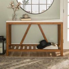 a wooden table with a mirror above it