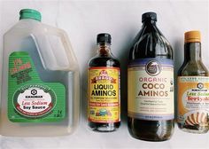 three bottles of liquid, one containing almond oil and the other containing an orange juice