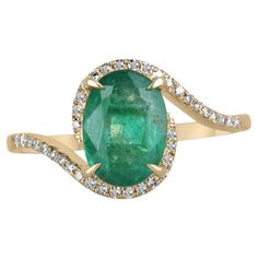 A beautiful, oval emerald and diamond ladies' ring. The center gemstone features a lovely 1.65-carat, natural oval-cut emerald with remarkable qualities. Carefully prong set, with micro-pave set diamonds accenting the bypass shank. Crafted in gleaming 14K yellow gold. Setting Style: Prong/Pave Setting Material: 14K Yellow Gold Setting Weight: 2.3 Grams Main Stone: Emerald Shape: Oval Cut Weight: 1.65-Carats Clarity: Semi-Transparent Color: Lush Dark Green Luster: Good Treatments: Natural, Oiling Split Shank Engagement Rings, Ring Rosegold, Split Shank Ring, Pearl Necklace Set, Modern Engagement Rings, Bypass Ring, Ladies Ring, Yellow Gold Setting, Modern Ring