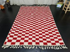 a red and white checkered rug on the floor