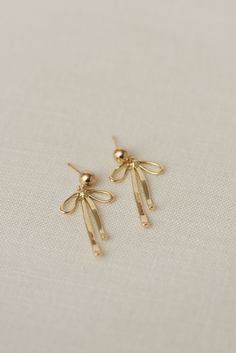 Rumor has is that 2024 is the year of BOWS! These super cute, dangly bow earrings will be the HIT of any party. Includes two gold or silver-plated dangly bow charms 6mm 14k gold-filled or sterling silver, hypoallergenic ball studs Choose from either solid or sparkly Delicate Earrings Gold, It Girl Earrings, Bow Gold Earrings, Dainty Jewelry Earrings, Gold Dangly Earrings, Bow Earrings Gold, Gold Bow Earrings, Quince Earrings, Fancy Gold Earrings