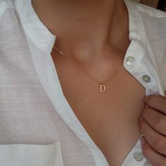 Discover elegance in simplicity with our Gold Plated Tiny Pave Initial Letter Necklace. This personalized pendant is a delicate and sophisticated addition to your jewelry collection, perfect for bridesmaids, weddings, or as a thoughtful minimalist bridal party gift. The tiny pave gold plated initial pendant adds a touch of glamour to any outfit. The dainty design makes it versatile for everyday wear. The upper case initial adds a personalized touch, making it a truly unique and meaningful accessory. Whether you're looking for a bridesmaid gift, a wedding keepsake, or simply a minimalist piece to elevate your style, this Gold Plated Tiny Pave Initial Letter Necklace is the epitome of understated beauty. Treat yourself or a loved one to this timeless and personalized jewelry piece that will Minimalist Gold Initial Necklace For Bridesmaids, Gold Minimalist Initial Necklace For Bridesmaids, Elegant Initial Necklace For Bridesmaid Gift, Rose Gold Dainty Initial Necklace With Clavicle Chain, Elegant Initial Pendant Necklaces For Bridesmaid Gift, Dainty Rose Gold Initial Necklace With Clavicle Chain, Simple Charm Necklace With Initial Pendant, Minimalist Initial Pendant Jewelry For Bridesmaid Gift, Elegant Initial Pendant Charm Necklace For Bridesmaids