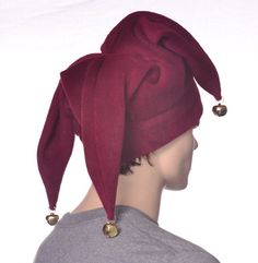 Three pointed jester hat made in burgundy fleece. This is a joker style fools cap, one point in the front with two points to the rear side. Each of the point are tipped of with a silver jingle bell. Red double thick headband. One size fits most adults 22-24 inch heads. Christmas Jester Gifts, Jester Hat Sewing Pattern, Jester Hat Pattern, Jester Outfits, Jester Halloween Costume, Jester Aesthetic, Jester Halloween, Jester Outfit, Joker Halloween Costume