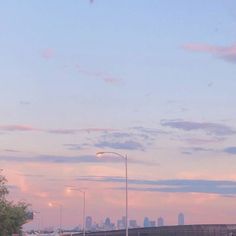 an empty street in front of a city skyline