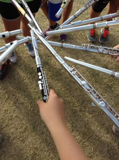 a group of people standing around each other holding onto metal poles