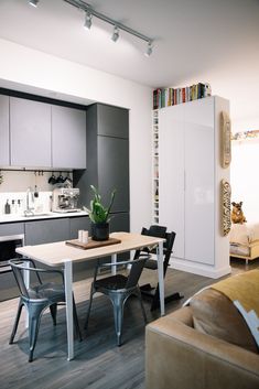 a dining room table with chairs and a couch