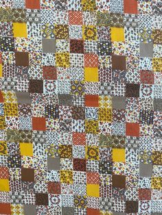 an orange, yellow and brown patchwork quilt