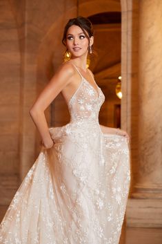 a woman in a wedding dress posing for the camera