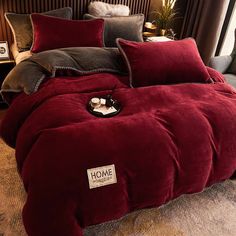 a bed covered in red and black comforters