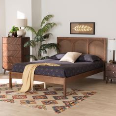 a bed sitting on top of a wooden floor next to a dresser