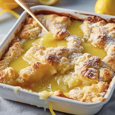 a casserole dish with lemons and powdered sugar on the side, ready to be eaten