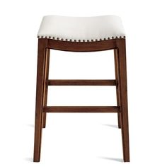 a wooden stool with white upholstered seat and nail polishing on the back