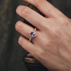 a person's hand with a ring on it