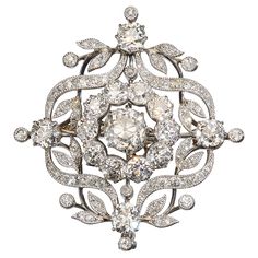 A Belle Époque diamond brooch, set with a cushion shaped old-cut diamond, in the centre, weighing approximately 1.82 carat, in our opinion the colour is I-J, with a surrounding cluster of ten old-cut diamonds, with an approximate total weight of 2.30 carats, in claw settings, bordered by a garland of ribbons, leaves and buds, with single old-cut diamonds, in claw settings, set above, below and either side, with a total weight of approximately 1.60 carat, in grain settings, with millegrain edges, Diamond Flower Brooch, Diamond Cufflink, Diamond Crown, Diamond Brooch, Classy Jewelry, Heart Shaped Diamond, Diamond Bangle, Fabulous Jewelry, Antique Diamond