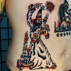 a woman's stomach with tattoos on it and an image of a wizard holding a wand