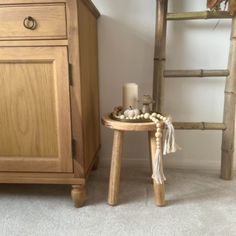 a small wooden table sitting next to a ladder