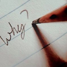 a person is writing on paper with a pencil