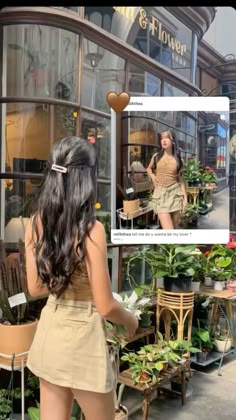 a woman standing in front of a flower shop