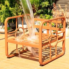 a wooden bench with water pouring out of it